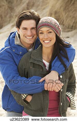 Romantic Young Couple On Winter Beach View Large Photo Image Stock Photo - Romantic Young Couple On Winter Beach. Fotosearch