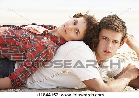 Romantic Young Couple Relaxing On Beach View Large Photo Image Stock Image - Romantic Young Couple Relaxing On Beach. Fotosearch