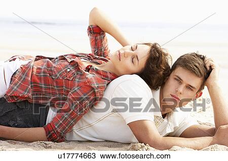 Romantic Young Couple Relaxing On Beach View Large Photo Image Stock Image - Romantic Young Couple Relaxing On Beach. Fotosearch