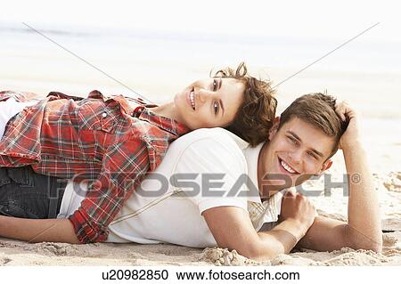 Romantic Young Couple Relaxing On Beach View Large Photo Image Stock Image - Romantic Young Couple Relaxing On Beach. Fotosearch
