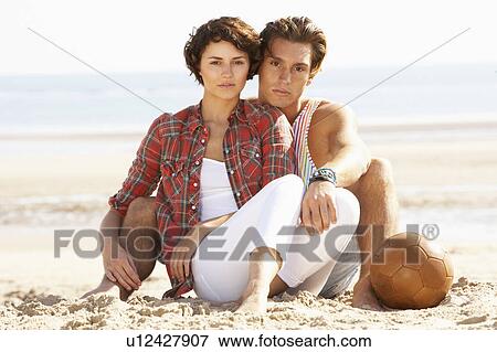 Romantic Young Couple Relaxing On Beach View Large Photo Image Stock Photo - Romantic Young Couple Relaxing On Beach. Fotosearch