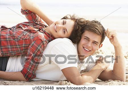 Romantic Young Couple Relaxing On Beach View Large Photo Image Stock Photo - Romantic Young Couple Relaxing On Beach. Fotosearch