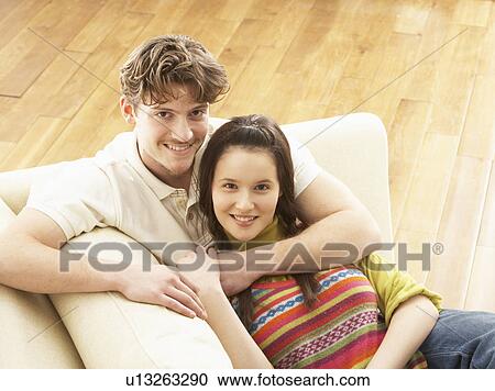 Romantic Young Couple Relaxing Sitting On Sofa View Large Photo Image Stock Image - Romantic Young Couple Relaxing Sitting On Sofa. Fotosearch