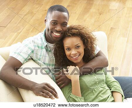 Romantic Young Couple Relaxing Sitting On Sofa View Large Photo Image Stock Image - Romantic Young Couple Relaxing Sitting On Sofa. Fotosearch