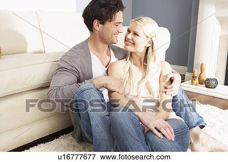 Stock Photo - Romantic Young Couple Relaxing Together At Home . Fotosearch