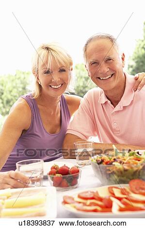 Senior couple eating outdoors View Large Photo Image Stock Photo - Senior couple eating outdoors. Fotosearch