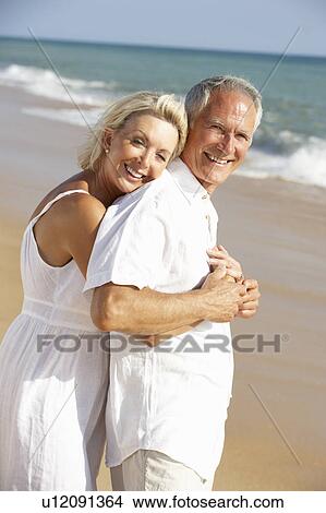 Picture - Senior Couple Enjoying Beach Holiday. Fotosearch