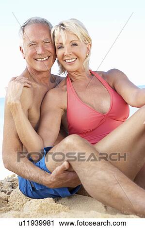 Stock Image - Senior Couple Enjoying Beach Holiday. Fotosearch