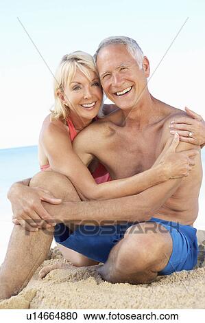 Stock Image - Senior Couple Enjoying Beach Holiday. Fotosearch