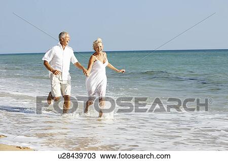 Senior Couple Enjoying Beach Holiday View Large Photo Image Stock Image - Senior Couple Enjoying Beach Holiday. Fotosearch
