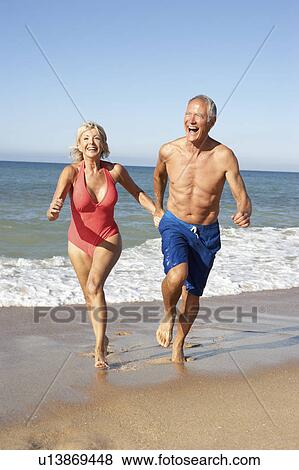 Senior Couple Enjoying Beach Holiday View Large Photo Image Stock Photo - Senior Couple Enjoying Beach Holiday. Fotosearch