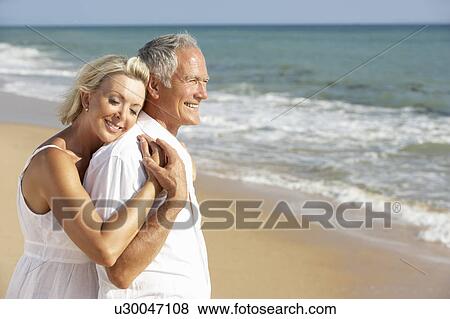Stock Photo - Senior Couple Enjoying Beach Holiday. Fotosearch