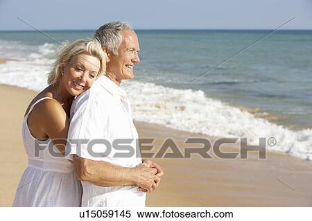 Stock Photography - Senior Couple Enjoying Beach Holiday. Fotosearch