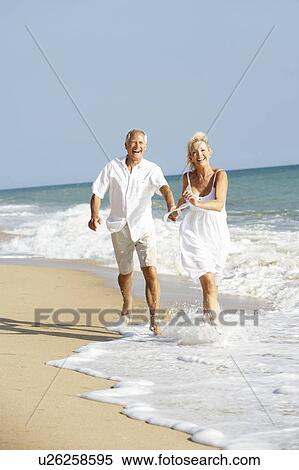 Senior Couple Enjoying Beach Holiday View Large Photo Image Stock Photography - Senior Couple Enjoying Beach Holiday. Fotosearch