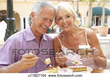 Picture - Senior Couple Enjoying Coffee And Cake In Café. Fotosearch