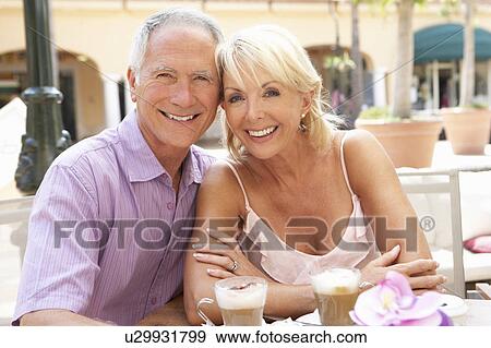 Stock Photo - Senior Couple Enjoying Coffee And Cake In Café. Fotosearch