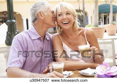 Stock Photo - Senior Couple Enjoying Coffee And Cake In Café. Fotosearch