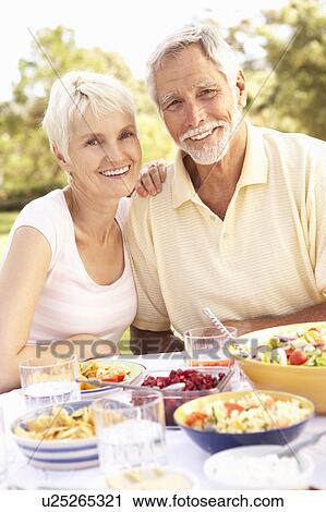 Senior Couple Enjoying Meal In Garden View Large Photo Image Stock Image - Senior Couple Enjoying Meal In Garden. Fotosearch