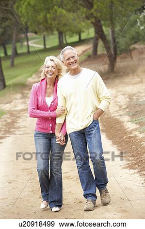 Senior Couple enjoying walk in park View Large Photo Image Stock Photo - Senior Couple enjoying walk in park. Fotosearch