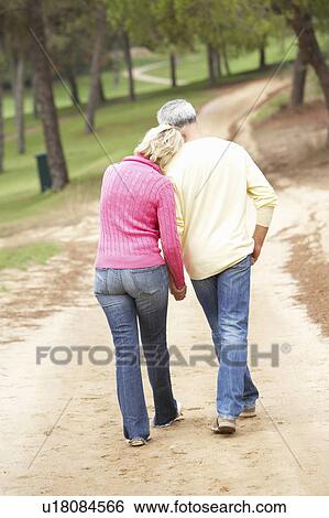 Senior Couple enjoying walk in park View Large Photo Image Stock Photograph - Senior Couple enjoying walk in park. Fotosearch
