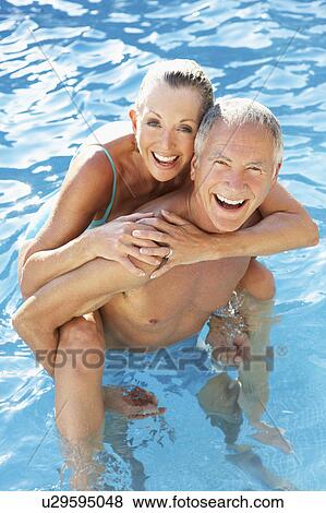 Senior couple having fun in pool View Large Photo Image Stock Photo - Senior couple having fun in pool. Fotosearch