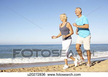 Senior Couple In Fitness Clothing Running Along Beach View Large Photo Image Stock Photograph - Senior Couple In Fitness Clothing Running Along Beach. Fotosearch