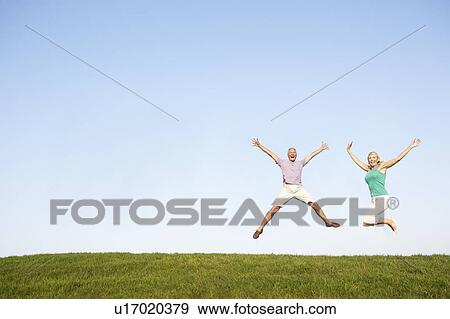Senior couple jumping in air View Large Photo Image Stock Photo - Senior couple jumping in air. Fotosearch