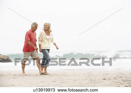 Senior Couple On Holiday Running Along Winter Beach View Large Photo Image Stock Image - Senior Couple On Holiday Running Along Winter Beach. Fotosearch