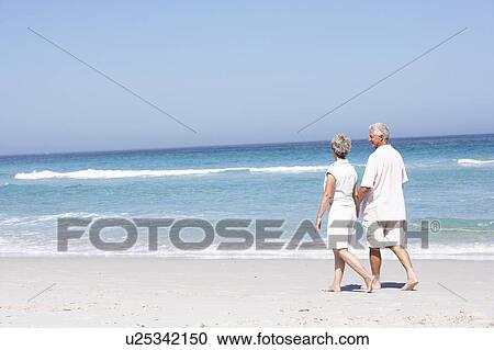 Senior Couple On Holiday Running Along Sandy Beach View Large Photo Image Stock Image - Senior Couple On Holiday Running Along Sandy Beach. Fotosearch