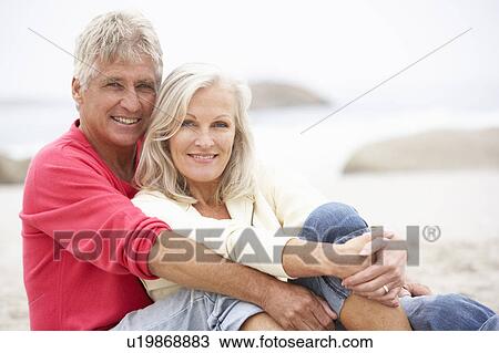 Senior Couple On Holiday Sitting On Winter Beach View Large Photo Image Stock Image - Senior Couple On Holiday Sitting On Winter Beach. Fotosearch