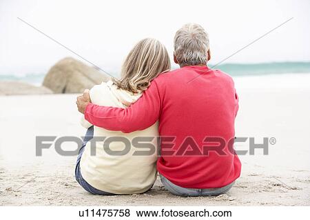 Senior Couple On Holiday Sitting On Winter Beach View Large Photo Image Stock Photo - Senior Couple On Holiday Sitting On Winter Beach. Fotosearch
