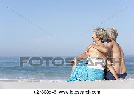 Senior Couple On Holiday Sitting On Sandy Beach View Large Photo Image Stock Photograph - Senior Couple On Holiday Sitting On Sandy Beach. Fotosearch