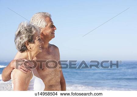 Senior Couple On Holiday Walking Along Sandy Beach View Large Photo Image Picture - Senior Couple On Holiday Walking Along Sandy Beach. Fotosearch