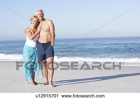 Senior Couple On Holiday Walking Along Sandy Beach View Large Photo Image Stock Image - Senior Couple On Holiday Walking Along Sandy Beach. Fotosearch