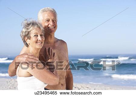 Senior Couple On Holiday Walking Along Sandy Beach View Large Photo Image Stock Photography - Senior Couple On Holiday Walking Along Sandy Beach. Fotosearch