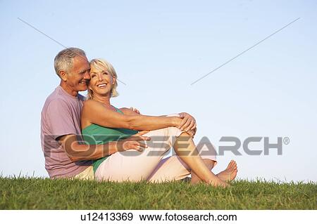 Stock Photo - Senior couple posing on a field. Fotosearch