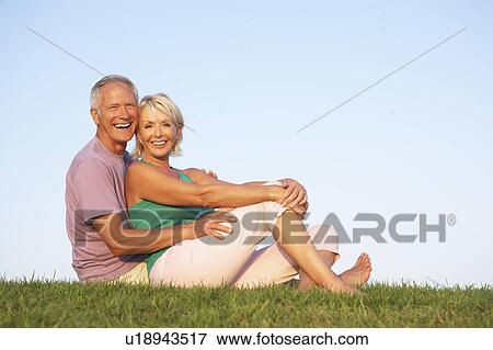 Senior couple posing on a field View Large Photo Image Stock Photo - Senior couple posing on a field. Fotosearch