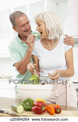 Senior Couple Preparing Salad In Modern Kitchen View Large Photo Image Picture - Senior Couple Preparing Salad In Modern Kitchen. Fotosearch