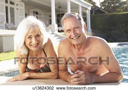Senior Couple Relaxing by Outdoor Pool View Large Photo Image Stock Image - Senior Couple Relaxing by Outdoor Pool. Fotosearch