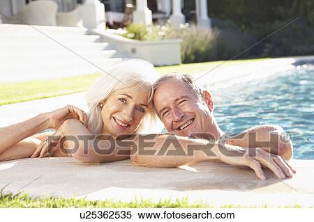 Senior Couple Relaxing by Outdoor Pool View Large Photo Image Stock Photography - Senior Couple Relaxing by Outdoor Pool. Fotosearch