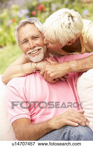 Stock Photo - Senior Couple Relaxing In Garden. Fotosearch