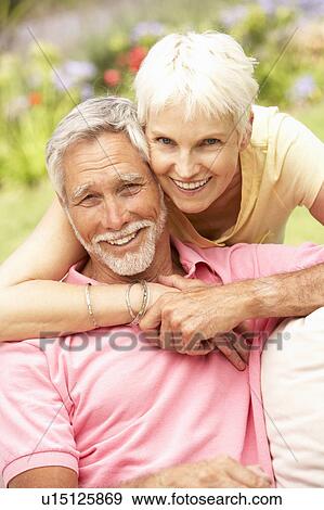 Senior Couple Relaxing In Garden View Large Photo Image Stock Photo - Senior Couple Relaxing In Garden. Fotosearch
