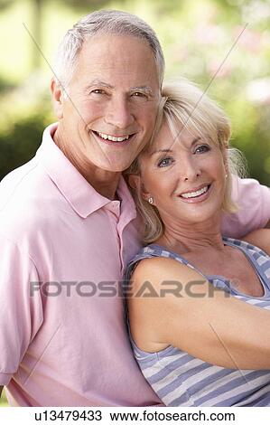 Senior couple relaxing together in park View Large Photo Image Stock Image - Senior couple relaxing together in park. Fotosearch