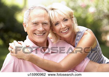Senior couple relaxing together in park View Large Photo Image Stock Image - Senior couple relaxing together in park. Fotosearch