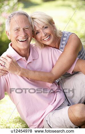 Senior couple relaxing together in park View Large Photo Image Stock Photo - Senior couple relaxing together in park. Fotosearch