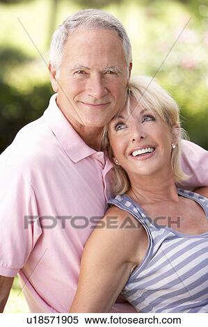 Stock Photography - Senior couple relaxing together in park. Fotosearch