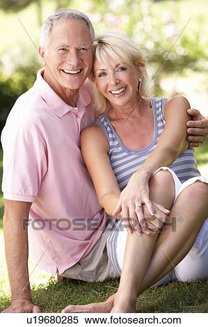 Senior couple relaxing together in park View Large Photo Image Stock Photography - Senior couple relaxing together in park. Fotosearch