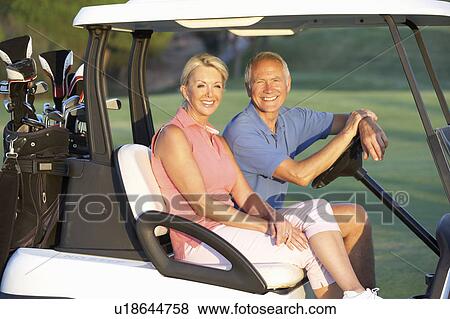 Senior Couple Riding In Golf Buggy On Golf Course View Large Photo Image Stock Photo - Senior Couple Riding In Golf Buggy On Golf Course. Fotosearch