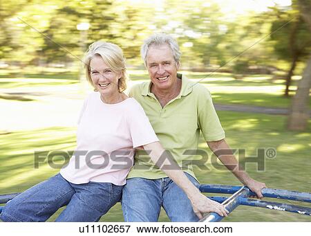 Senior Couple Riding On Roundabout In Park View Large Photo Image Stock Photo - Senior Couple Riding On Roundabout In Park. Fotosearch