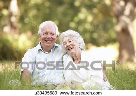 Stock Photo - Senior Couple Sitting In Park. Fotosearch